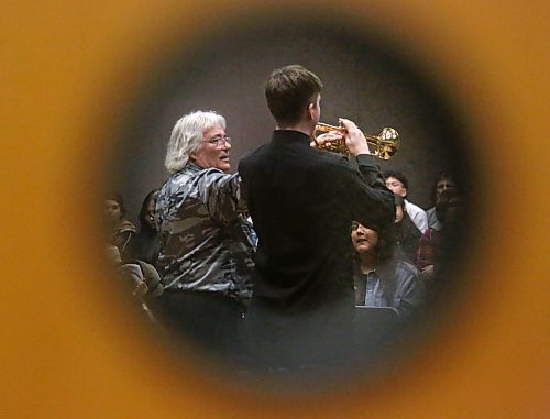 A small glass window set in the front doors of the Kinsmen Rehearsal Hall at Brandon University perfectly frames Prof. Edward Bach as he offers an impromptu trumpet lesson to Leland Klassen of Garden City Collegiate in Winnipeg, during a trumpet masterclass offered by Prof. Bach for BU's three-day Jazz Festival. (Matt Goerzen/The Brandon Sun)