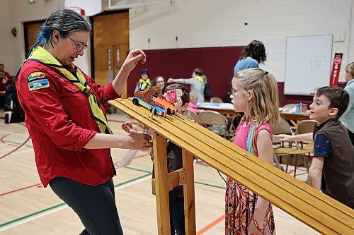 A Westman scout leader gets the cars ready at the starting line during during the races at the Kubkar Regional Rally held at Ecole New Era School gym on Saturday. Prizes were awarded for the fastest as well as best design. (Michele McDougall/The Brandon Sun)