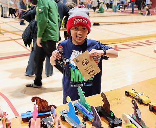 Seven year old Sebastian Rocero, a Beaver from Brandon, holds up his winning car and plaque for his first place finish at the Kubkar Regional Rally held at Ecole New Era School gym on Saturday. Prizes were awarded for the fastest as well as best design. (Michele McDougall/The Brandon Sun)