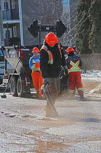 An employee with Manitoba Transportation and Infrastructure blows out the water and rubble from a pothole on First Street on Tuesday afternoon. The province had two road repair crews working on Tuesday, with one on First Street and the other on 18th Street. (Matt Goerzen/The Brandon Sun)