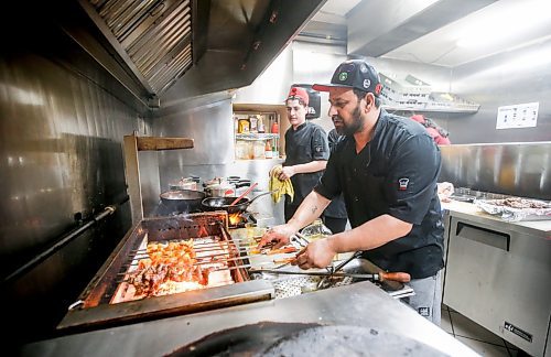JOHN WOODS / FREE PRESS
Jehangir Khan, owner of the Barbecue Hut, prepares a dish for an Iftar buffet Tuesday, March 19, 2024. 

Reporter: av