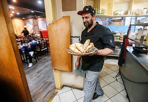 JOHN WOODS / FREE PRESS
Jehangir Khan, owner of the Barbecue Hut, brings some bread to an Iftar buffet table Tuesday, March 19, 2024. 

Reporter: av