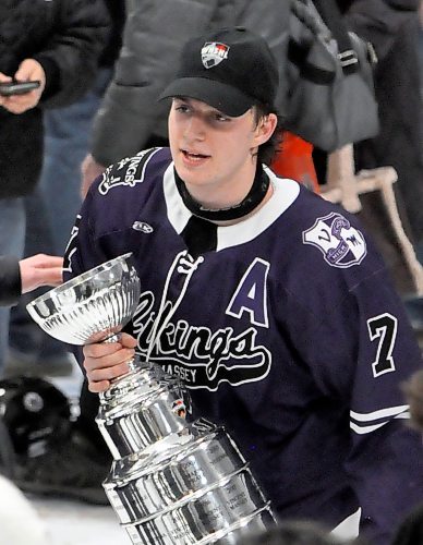 Vincent Massey Vikings sniper Carter Dittmer, who led the WHSHL in scoring during the 2023-24 season, clutches the championship trophy Wednesday night while looking for family to share it with on the ice in Neepawa. (Jules Xavier/The Brandon Sun)