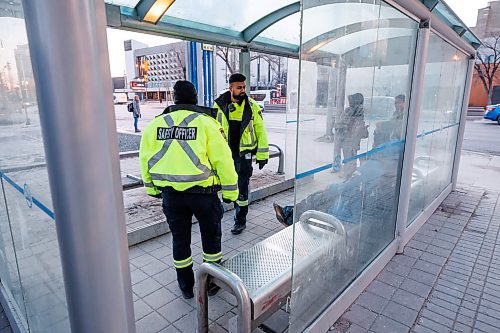 MIKE DEAL / WINNIPEG FREE PRESS
Community Safety Officers check the wellbeing of a person in the bus stop outside City Hall on Main Street early Friday morning.
See Malak Abas story
240322 - Friday, March 22, 2024.