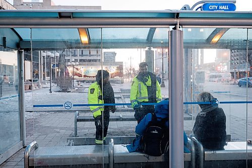 MIKE DEAL / WINNIPEG FREE PRESS
Community Safety Officers check the wellbeing of a person in the bus stop outside City Hall on Main Street early Friday morning.
See Malak Abas story
240322 - Friday, March 22, 2024.