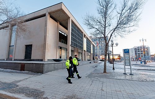 MIKE DEAL / WINNIPEG FREE PRESS
Community Safety Officers check out the bus stop outside City Hall on Main Street early Friday morning.
See Malak Abas story
240322 - Friday, March 22, 2024.