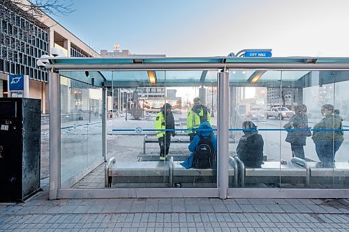 MIKE DEAL / WINNIPEG FREE PRESS
Community Safety Officers check the wellbeing of a person in the bus stop outside City Hall on Main Street early Friday morning.
See Malak Abas story
240322 - Friday, March 22, 2024.