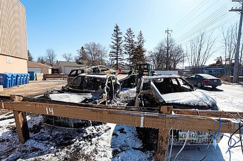 MIKE DEAL / FREE PRESS
Three completely incinerated vehicles are being towed away from the parking lot at 9 Mandalay Drive Friday. 
240322 - Friday, March 22, 2024