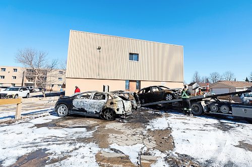 MIKE DEAL / FREE PRESS
Three completely incinerated vehicles are being towed away from the parking lot at 9 Mandalay Drive Friday. 
240322 - Friday, March 22, 2024