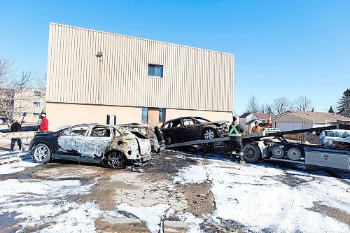 MIKE DEAL / FREE PRESS
Three completely incinerated vehicles are being towed away from the parking lot at 9 Mandalay Drive Friday. 
240322 - Friday, March 22, 2024