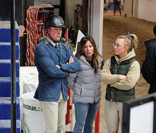 Horse show jumper Piet Van Genugten from Okotoks, Alta., watches a hunter jumper class as he prepares for his next ride during day one of the Royal Manitoba Winter Fair on Monday. (Michele McDougall/The Brandon Sun)    