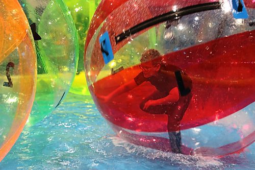 A fair-goer tries to stand up inside a wobbly water ball in the children's area set up in the Manitoba Room during day one of the Royal Manitoba Winter Fair on Monday. (Michele McDougall/The Brandon Sun)
