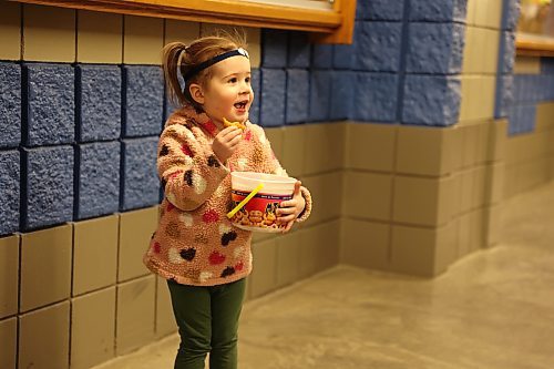 Two-year-old Kiara from Brandon enjoys a mini-donut during the first day of the Royal Manitoba Winter Fair on Monday. (Michele McDougall/The Brandon Sun)  