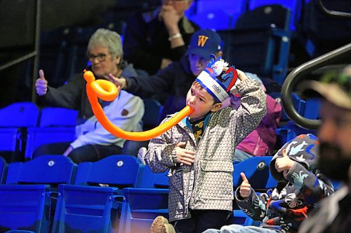 Six-year-old Lucas Clark pats his head and rubs his tummy during the Amanda Panda Hoola Hoop Circus show on Monday afternoon, while holding a balloon animal in his mouth. (Matt Goerzen/The Brandon Sun)