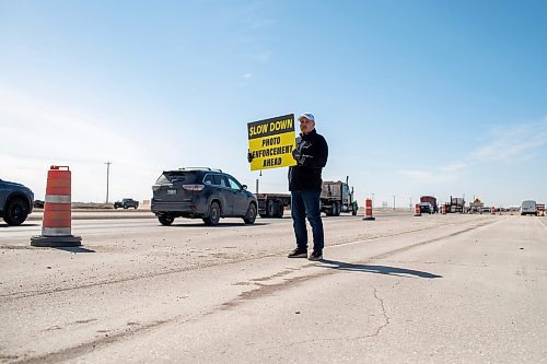 BROOK JONES / FREE PRESS
Todd Dube of Wise Up Winnipeg holds a sign alerting drivers to slow down because the Winnipeg Police Service is using photo radar and enforcement equipment to monitor the speed of vehicles and photograph vehicles that are speeding in the construction zone for the St. Mary's Road interchange at the Perimeter Highway in Winnipeg, Man., Monday, March 25, 2024.