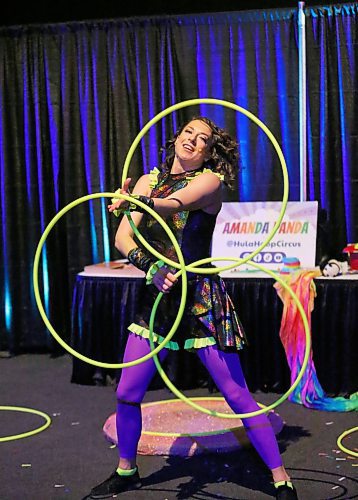 Amanda &quot;Panda&quot; Syryda, the star of the Hula Hoop Circus from Edmonton, AB., does a dance with three giant hoops as part of her early afternoon show on Monday during the first day of the Royal Manitoba Winter Fair. (Matt Goerzen/The Brandon Sun)
