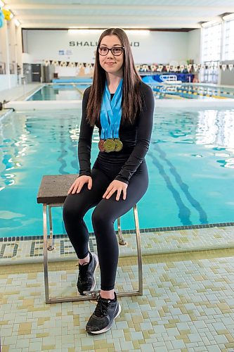 BROOK JONES / FREE PRESS
Junior Bisons Para swimmer Maxine Lavitt, 20, has three gold, three silver and one bronze medal around her neck that she won at the 2024 Speedo Western Canadian Championships which took place at the Pan Am Pool in Winnipeg, Man., March 21 to 24, 2024. Lavitt was pictured sitting on a swimming starting block at the Joyce Fromson Pool at the University of Manitoba Fort Garry campus in Winnipeg, Man., Monday, March 25, 2024.