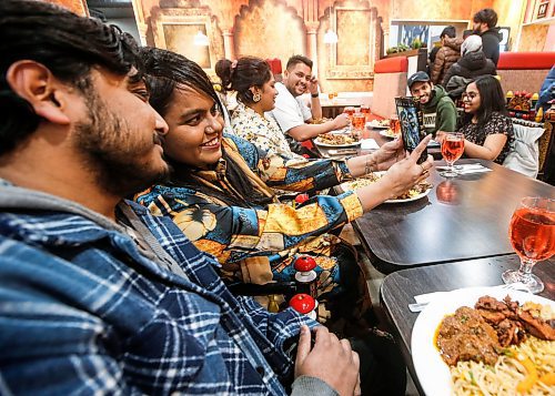 JOHN WOODS / FREE PRESS
Fariha Peu and Zafrul Hasan Shuvo, with their family and friends, take a photo of themselves at an Iftar buffet at the Barbecue Hut Tuesday, March 19, 2024. 

Reporter: av