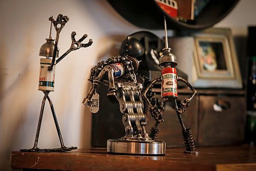 JOHN WOODS / FREE PRESS
Mike Beaudry, owner of Mad Mike Studio68, welds together found scraps of metal and other vintage objects to create robot sculptures in his workshop.
