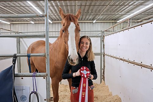 Karly Woods and Maverick the Canadian warmblood show off the first-place ribbon they won in the Gambler's Choice event on Monday night at the Royal Manitoba Winter Fair. It's the pair's first competition victory at an event Woods has been attending her whole life. (Colin Slark/The Brandon Sun)