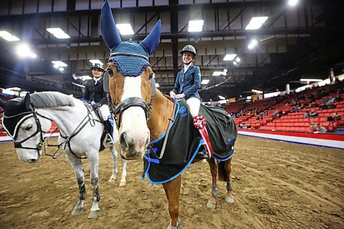 Sporting a first-place ribbon from the Gambler's Choice show jumping competition, winning horse Maverick enjoys the spotlight with her rider, Brandon's Karly Woods, all smiles during the opening night of the Royal Manitoba Winter Fair on Monday. (Matt Goerzen/The Brandon Sun)
