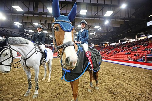 Sporting a first-place ribbon from the Gambler's Choice show jumping competition, winning horse Maverick enjoys the spotlight with her rider, Brandon's Karly Woods, all smiles during the opening night of the Royal Manitoba Winter Fair on Monday. (Matt Goerzen/The Brandon Sun)