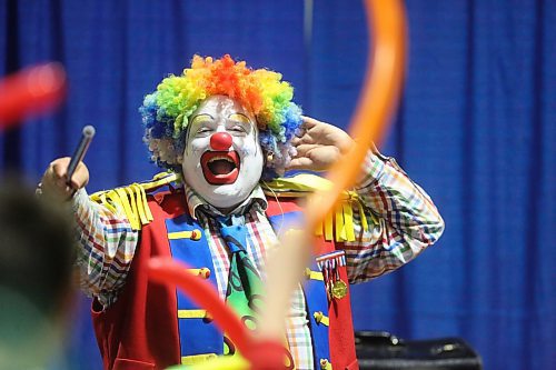 Doodles the Clown performs in front of a crowd of kids in the Royal Food Court at the Royal Manitoba Winter Fair on Tuesday. (Matt Goerzen/The Brandon Sun)