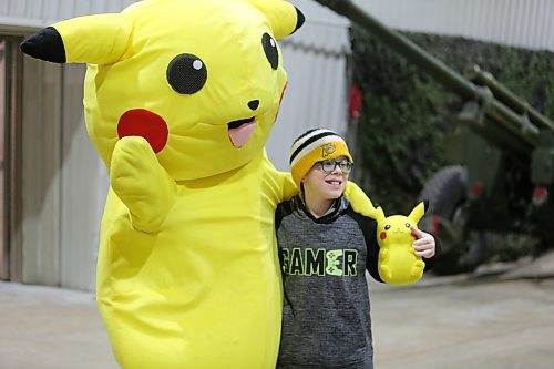 Pikachu the mouse, a character from the Pokémon video game and movie franchise, poses with a fan on Wednesday, which is Family Day - at the Royal Manitoba Winter Fair. (Michele McDougall/The Brandon Sun)
