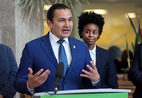 Manitoba Health Minister Uzoma Asagwara listens to Manitoba Premier Wab Kinew during his opening remarks inside the atrium at the Brandon Regional Health Centre on Wednesday afternoon. (Matt Goerzen/The Brandon Sun)