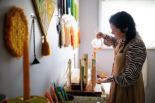 MIKAELA MACKENZIE / FREE PRESS

Lynsey Sable, who uses locally sourced beeswax and natural dyes to create unique candles, pours taper candles in her studio in La Broquerie on Monday, March 25, 2024. 

For AV story.