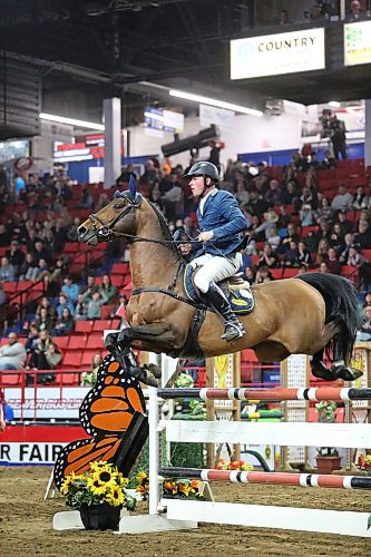 Piet Van Genugten from Okotoks, Alta. and his steed sail over a hurdle during the jump-off portion of the Manitoba Agriculture &amp; Provincial Ex of Manitoba Cup on Tuesday evening, part of the Royal Manitoba Winter Fair at the Westoba Place Arena. (Matt Goerzen/The Brandon Sun)