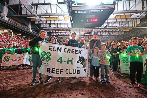 Members of the Elm Creek 4-H Beef Club proudly hold up their sign during the opening ceremonies of the Royal Manitoba Winter Fair on Tuesday evening in Westoba Place Arena. (Matt Goerzen/The Brandon Sun)