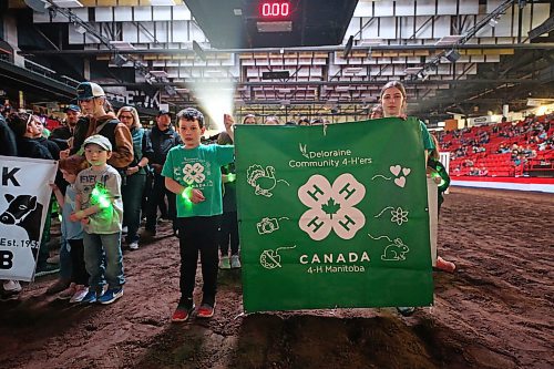 Members of the Deloraine 4-H Club hold up their sign during the Tuesday opening ceremonies of the Royal Manitoba Winter Fair evening show in the Westoba Place Arena. (Matt Goerzen/The Brandon Sun)