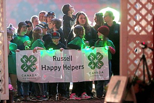 Members of the Russell Happy Helpers 4-H Club hold up their sign in the Westoba Place Arena on Tuesday during the opening ceremonies of the Royal Manitoba Winter Fair's evening show. (Matt Goerzen/The Brandon Sun) 