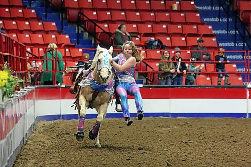 With her hair getting in her face, a member of the Truco Trick Riders group performs on Tuesday evening during the Royal Manitoba Winter Fair. (Matt Goerzen/The Brandon Sun)