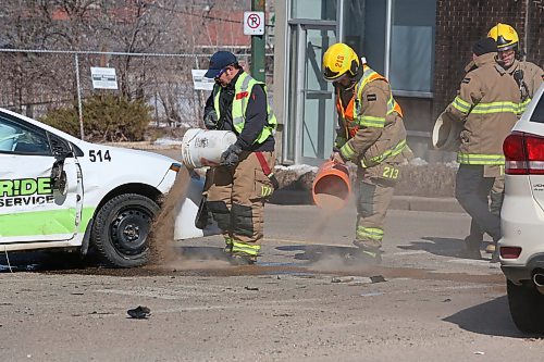 Emergency crews dump sand on leaking fuel following a collision between a taxi vehicle and a Dodge Journey at the corner of Sixth Street and Princess Avenue on Wednesday afternoon. (Matt Goerzen/The Brandon Sun)