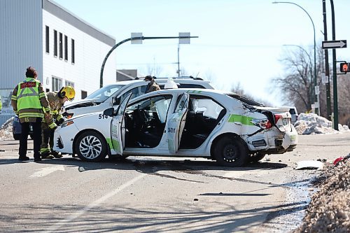 Emergency crews inspect a taxi vehicle and a Dodge Journey following a collision at the corner of Sixth Street and Princess Avenue on Wednesday afternoon. (Matt Goerzen/The Brandon Sun)