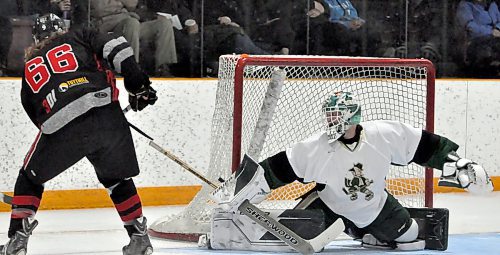 Killarney Shamrocks goaltender Brian Archibald has seen plenty of the three Bowles brothers playing for the Miniota-Elkhorn C-Hawks during the Tiger Hills Hockey League championship series. Here, he stops Brad Bowles (66) in close with a pad save at the Shamrock Centre during second period action. (Photos by Jules Xavier/The Brandon Sun)