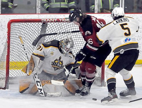 With Neepawa Titans defenceman Jace Larkins (5) moving in to defend on Virden Oil Capitals forward Grady Lane (16) during second period action, Titans goalie Mason Lobreau looks for the loose puck. (Jules Xavier/The Brandon Sun)
