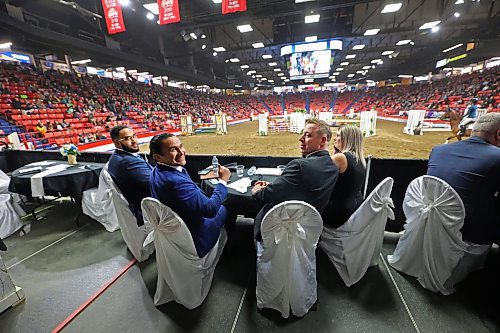 Manitoba Premier Wab Kinew, centre left, is joined by his assistant Seeon Smith at left, Provincial Exhibition of Manitoba president Clint Swain and wife Jenna Swain during the Wednesday evening show fo the Royal Manitoba Winter Fair in Brandon. (Matt Goerzen/The Brandon Sun)