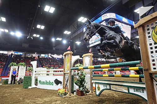 Abbey McLeod, riding Dicontendro, jumps the CFB Shilo hurdle during the Manitoba Agriculture &amp; Provincial Ex of Manitoba Cup jumping event on Tuesday evening as part of the Royal Manitoba Winter Fair. (Matt Goerzen/The Brandon Sun)