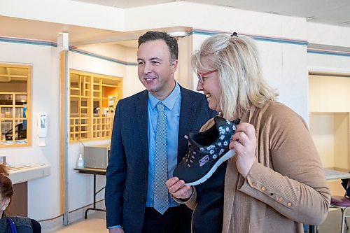BROOK JONES / FREE PRESS
Maja Kathan (right), who works as an occupational therapist at the Victoria General Hosptial, showing off a new pair of Skechers athletic shoes she received from Finance Minister Adrien Sala as part of the provincial government's pre-budget shoe event at the local hospital in Winnipeg, Man., Thursday, March 28, 2024. Sala handed out athletic shoes to five staff members at the Victoria Hospital.