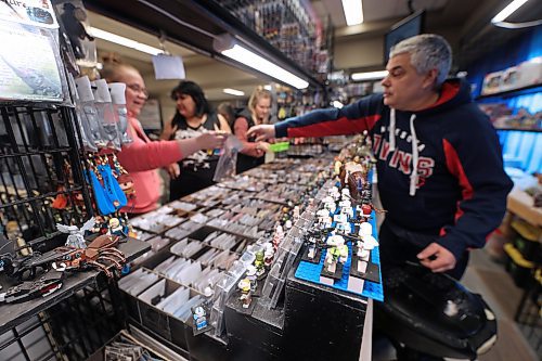 Jeff Karsko at the Mini Figures booth helps a customer buy an item on Thursday afternoon at the Royal Manitoba Winter Fair, just outside the northwest entrance of the Westoba Place Arena in the Keystone Centre. (Matt Goerzen/The Brandon Sun)
