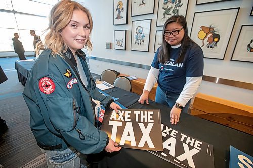 BROOK JONES / FREE PRESS
Cadence Cowel (left), 20, shows off an 'Axe the Tax' sign she picked up from Janice Wy, who is from Winnipeg North Conservative candidate Rachel Punzalan's team of supporters, during the Conservative Party of Canada Leader Pierre Poilievre's 'Spike the Hike - Axe the Tax' rally at the RBC Convention Centre in Winnipeg, Man., Thursday, March 28, 2024.