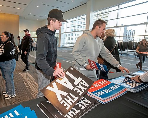 BROOK JONES / FREE PRESS
Dennis Drogalchuk (left) and Miguel Borges-Medeiros pick up signs during the Conservative Party of Canada Leader Pierre Poilievre's 'Spike the Hike - Axe the Tax' rally at the RBC Convention Centre in Winnipeg, Man., Thursday, March 28, 2024.