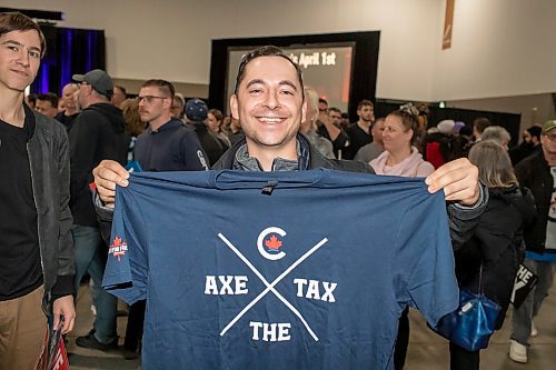 BROOK JONES / FREE PRESS
Winnipeg resident Bernie Arias holds up an 'Axe the Tax' T-shirt after Conservative Party of Canada Leader Pierre Poilievre spoke to a large crowd of supporters at his 'Spike the Hike - Axe the Tax' rally at the RBC Convention Centre in Winnipeg, Man., Thursday, March 28, 2024.