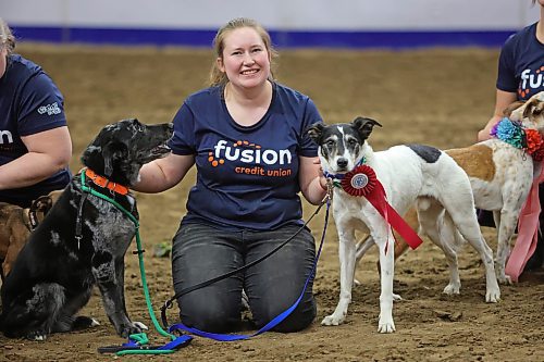 Sara van Renselaar from Brandon poses with her dogs, including Zero, the first place winner in the Dog/Horse Relay, on Wednesday evening, during the Royal Manitoba Winter Fair. (Matt Goerzen/The Brandon Sun)