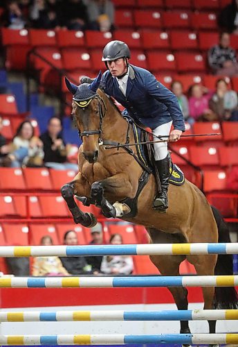 Piet Van Genugten stands tall in the saddle as he and Kannamara Equites attempt a jump in the Westoba Place Arena on Tuesday evening during the Royal Manitoba Winter Fair.  (Matt Goerzen/The Brandon Sun)