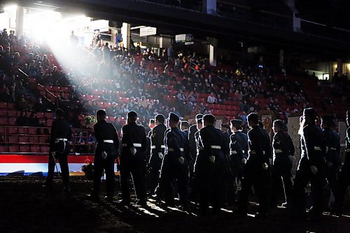 Cadets silhouetted in a bright spotlight march out of the Westoba Place Arena on Monday night during the opening ceremoniesr. (Matt Goerzen/The Brandon Sun)