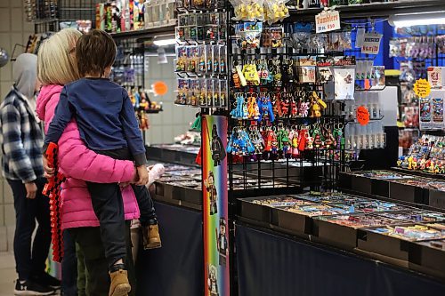 A woman with a young child look at the figurines at the Mini Figures booth at the Keystone Centre. (Matt Goerzen/The Brandon Sun)